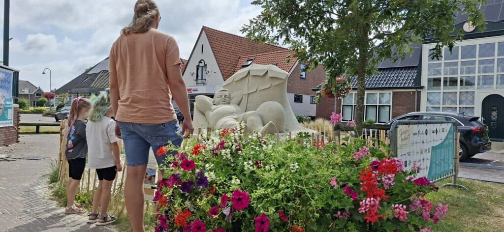 Zandsculpturen over het zonnebaden op het strand